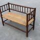 Vintage 'bobbin' bench with a rush seat, 1920s design with armrests.