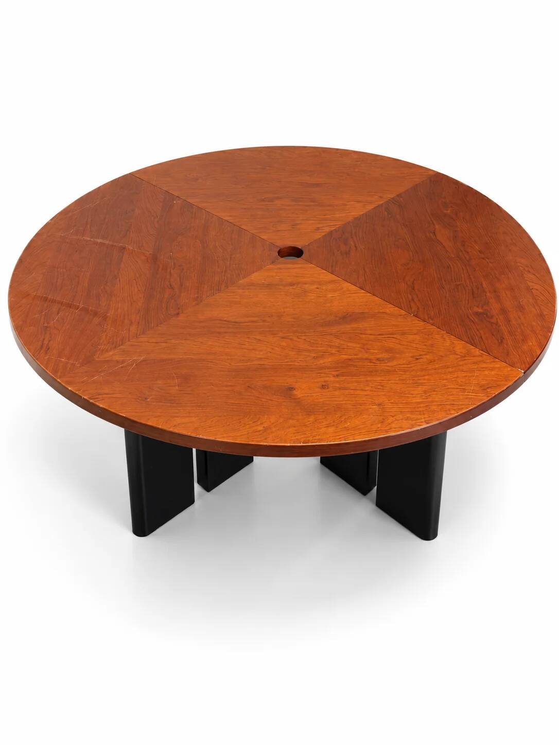Large round dining table with black blade legs.