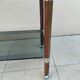 Vintage dessert table in wood, smoked glass, chrome metal, and wood.