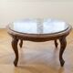 Classic round coffee table in wood with a marble top.