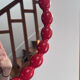 Round wall mirror with red beads in vintage retro design style.