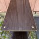 Brown rosewood rolling table with gold fluted legs