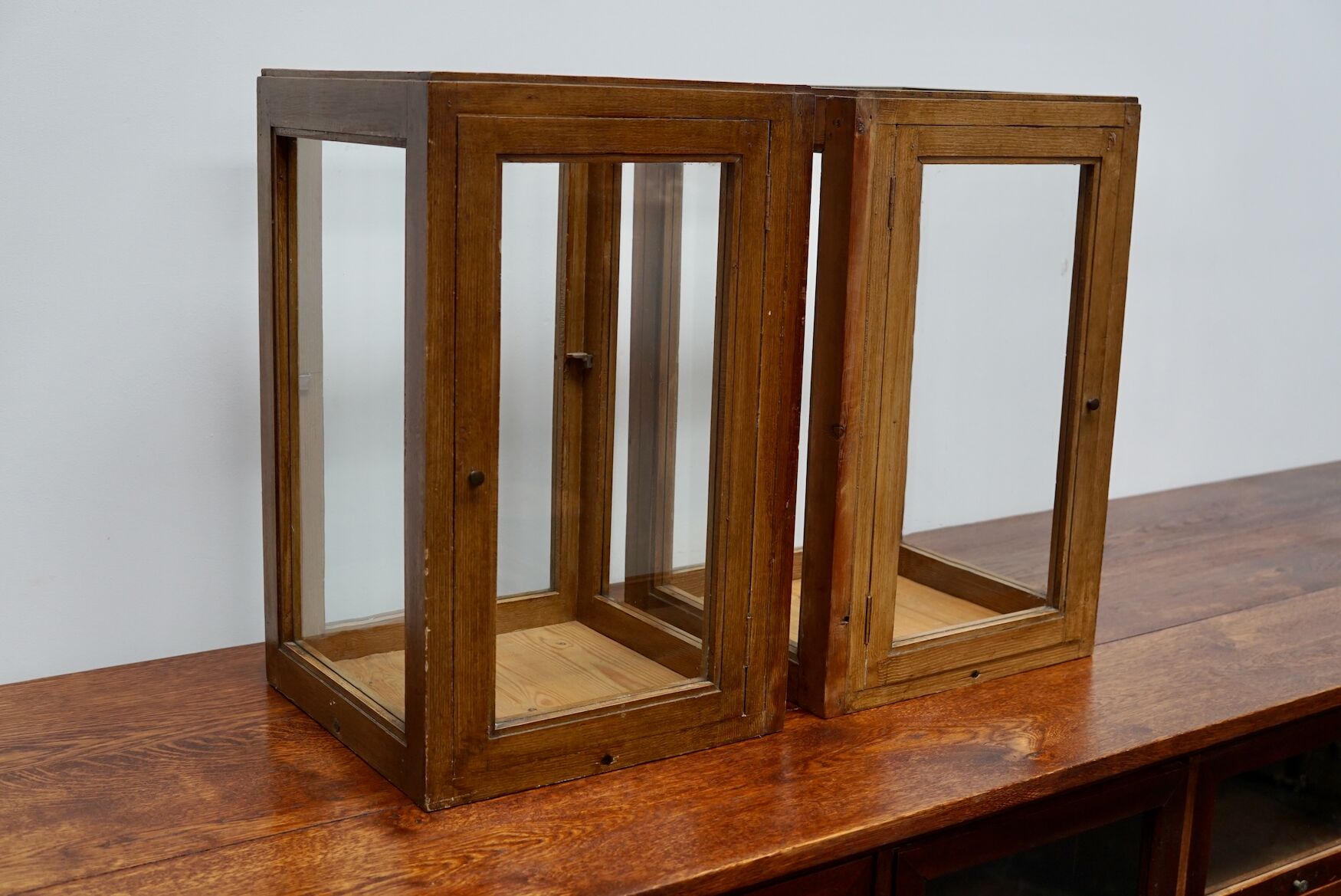 pair of faux oak shop display cabinets, circa 1920s