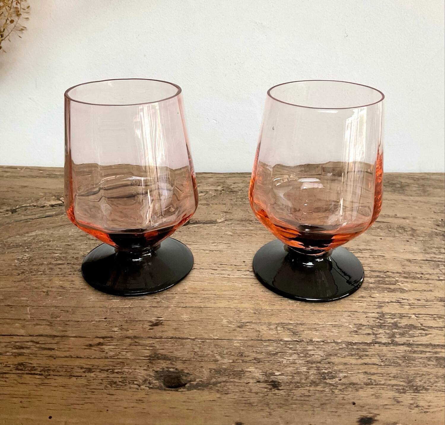 6 small pink glasses with black stems