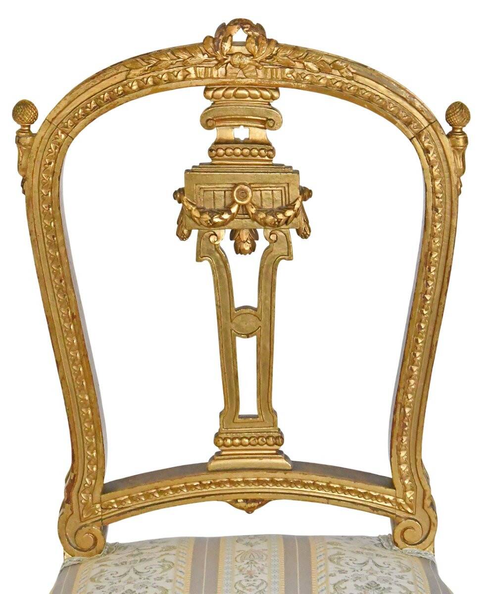 Pair of Louis XVI style chairs in gilded wood.