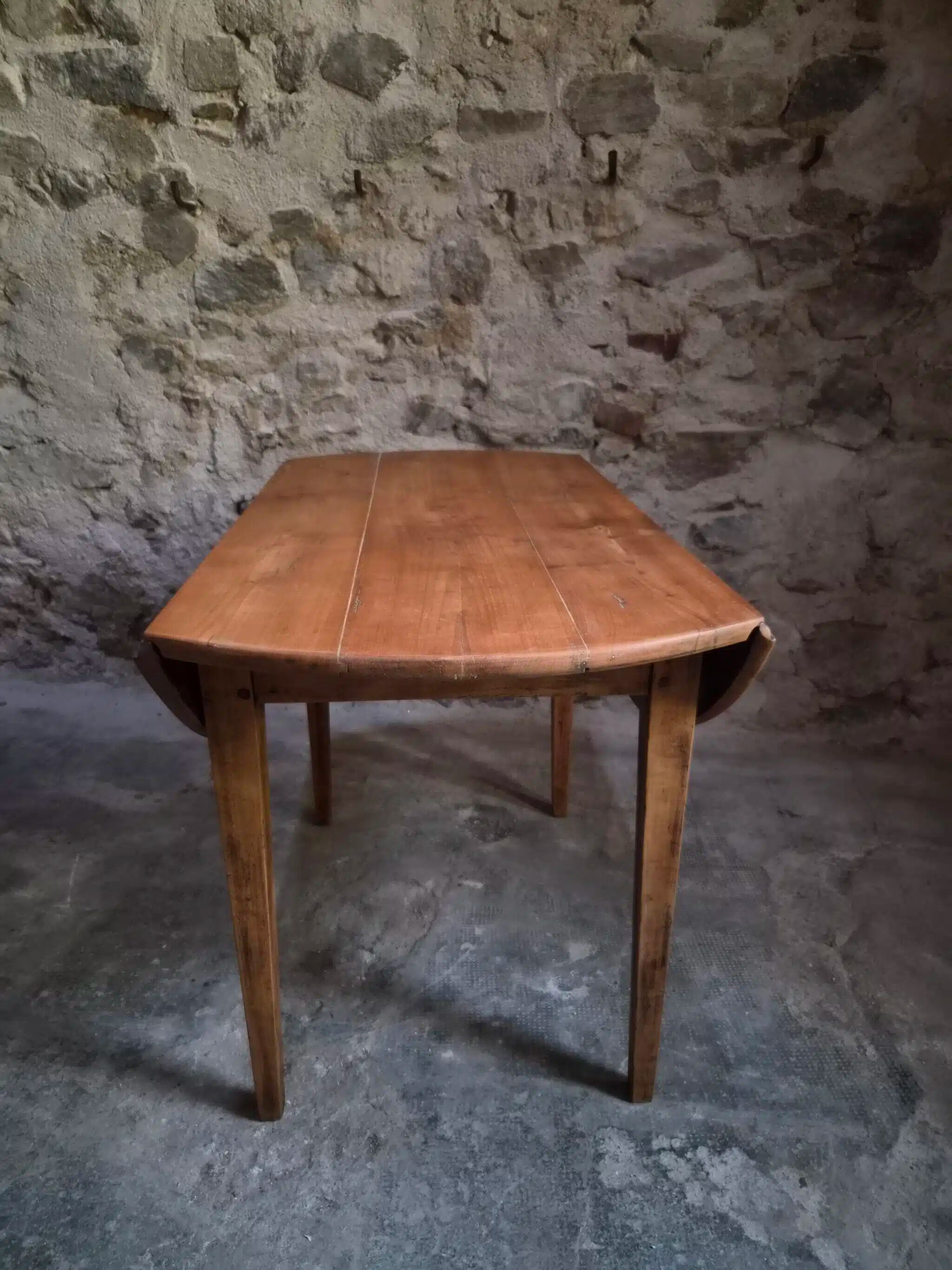 Rustic French antique dining table, drop-leaf table in cherry wood, circa 1900.