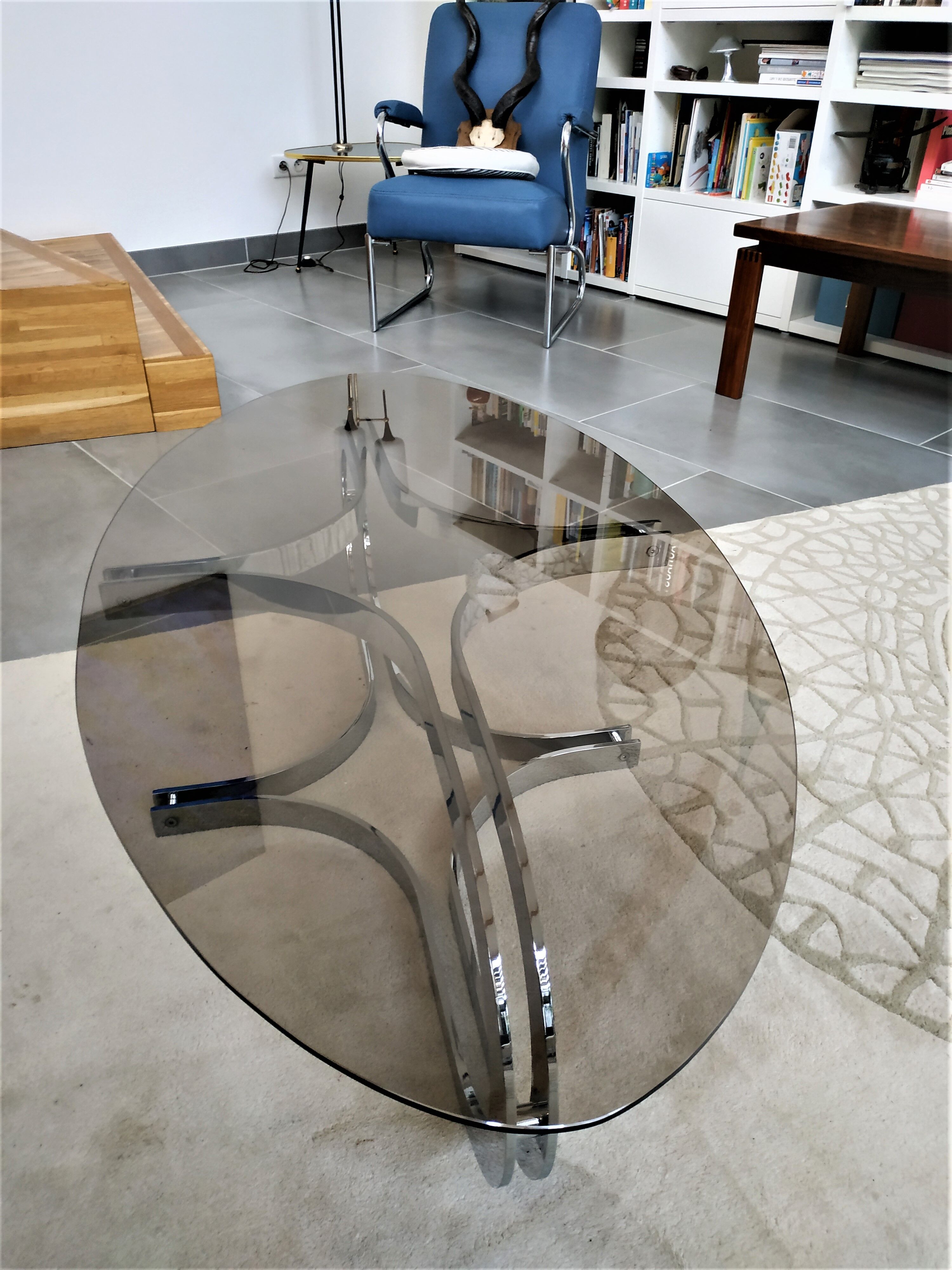 Chrome metal coffee table and oval smoked glass tray
