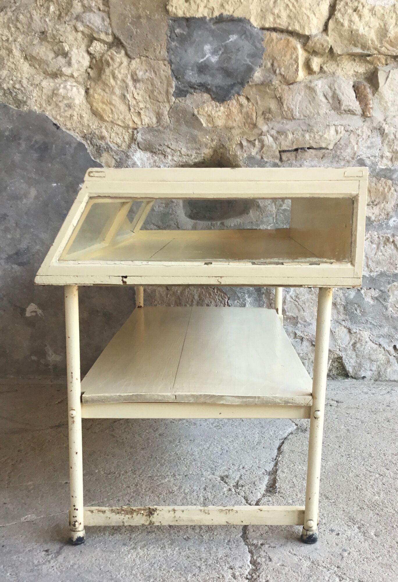 Old showcase on tubular metal feet - early twentieth century