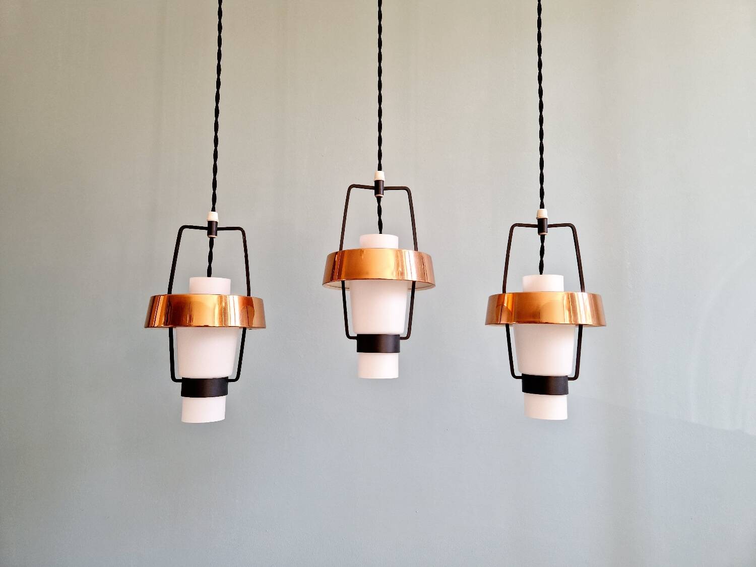Trio of Scandinavian pendant lights in opaline and copper metal, 1960s