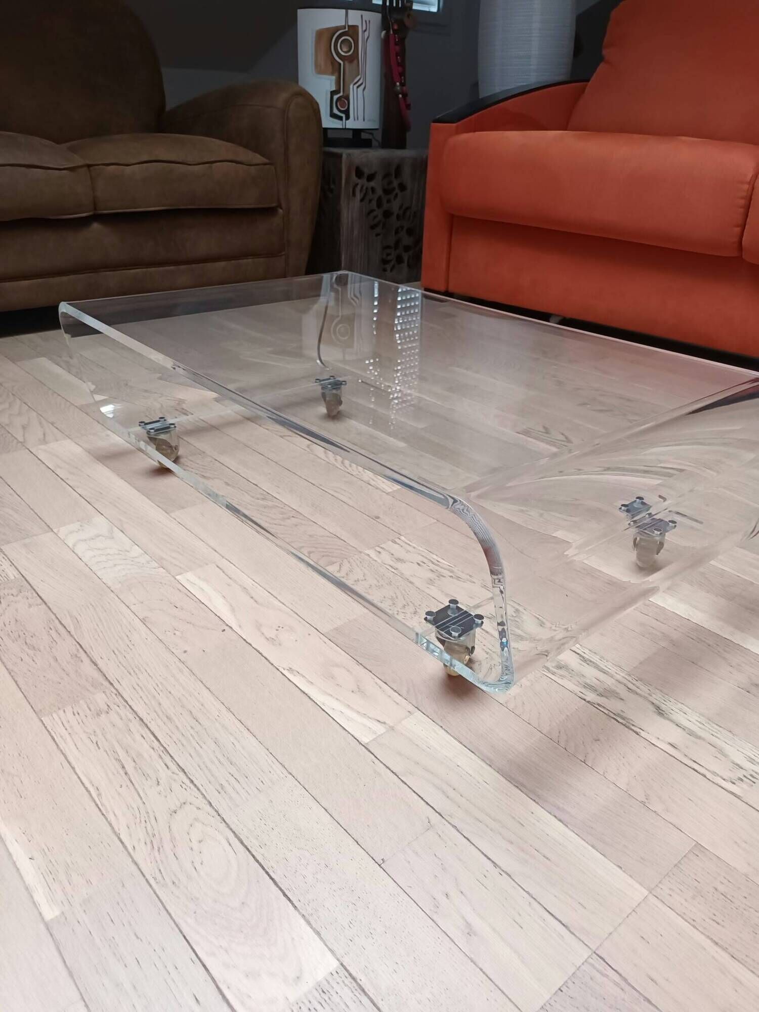 Design coffee table from Habitat in transparent plexiglass, mounted on wheels.