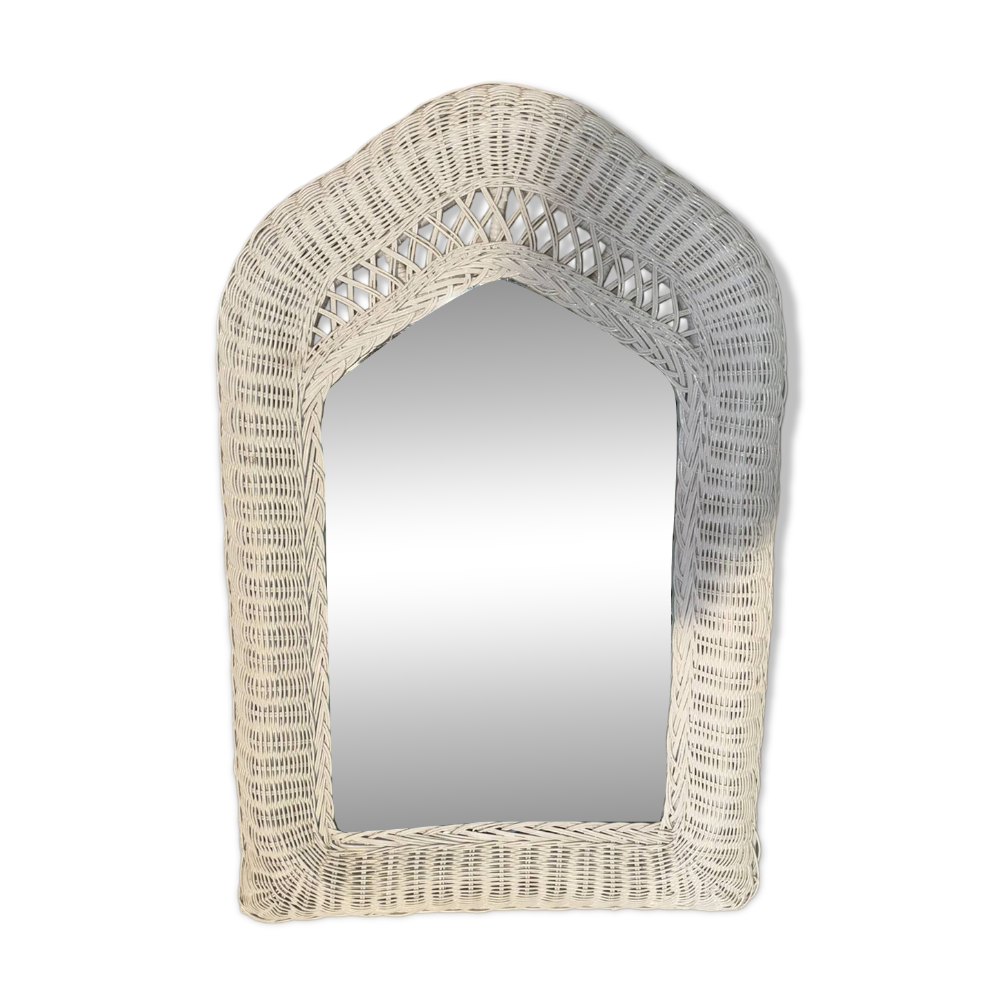 Vintage white rattan mirror with a gothic frame.