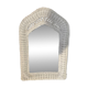 Vintage white rattan mirror with a gothic frame.