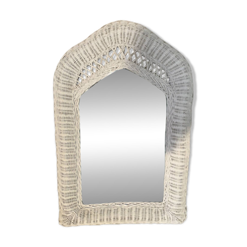 Vintage white rattan mirror with a gothic frame.