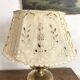 Antique brass lamp with embroidered openwork shade.