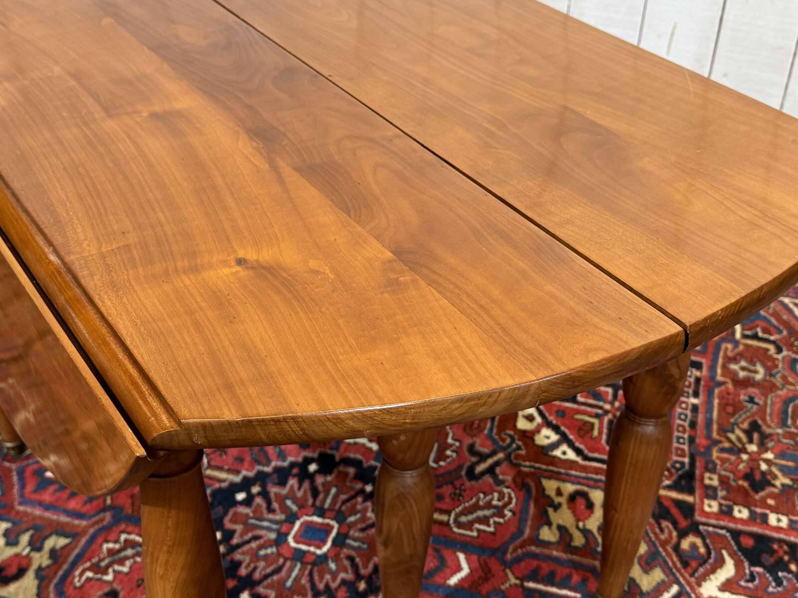 Round cherry wood table, 6 feet, Louis Philippe style with 2 extensions.