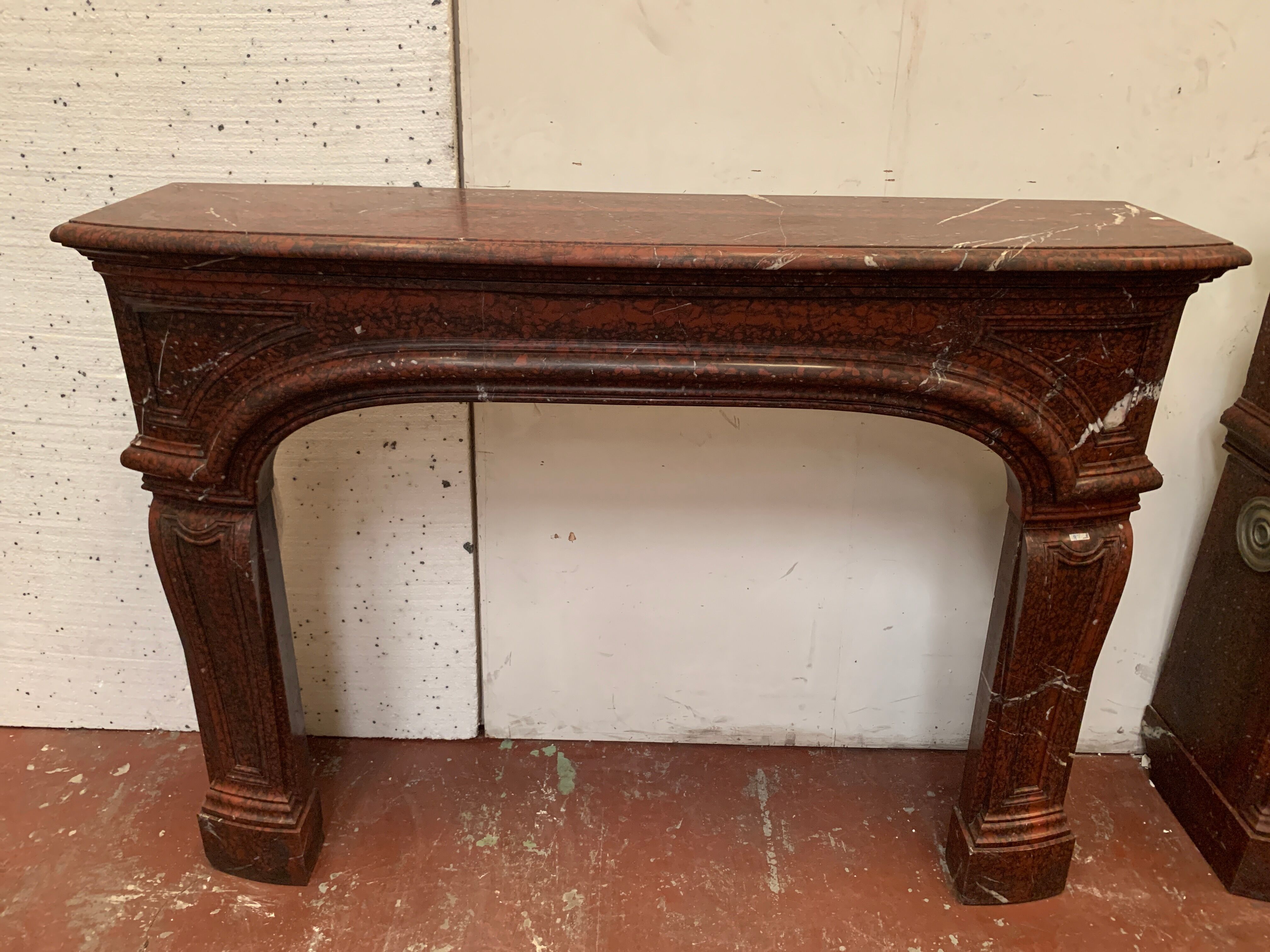 Pair of Louis XIV style fireplaces in red cherry marble. XIX century.