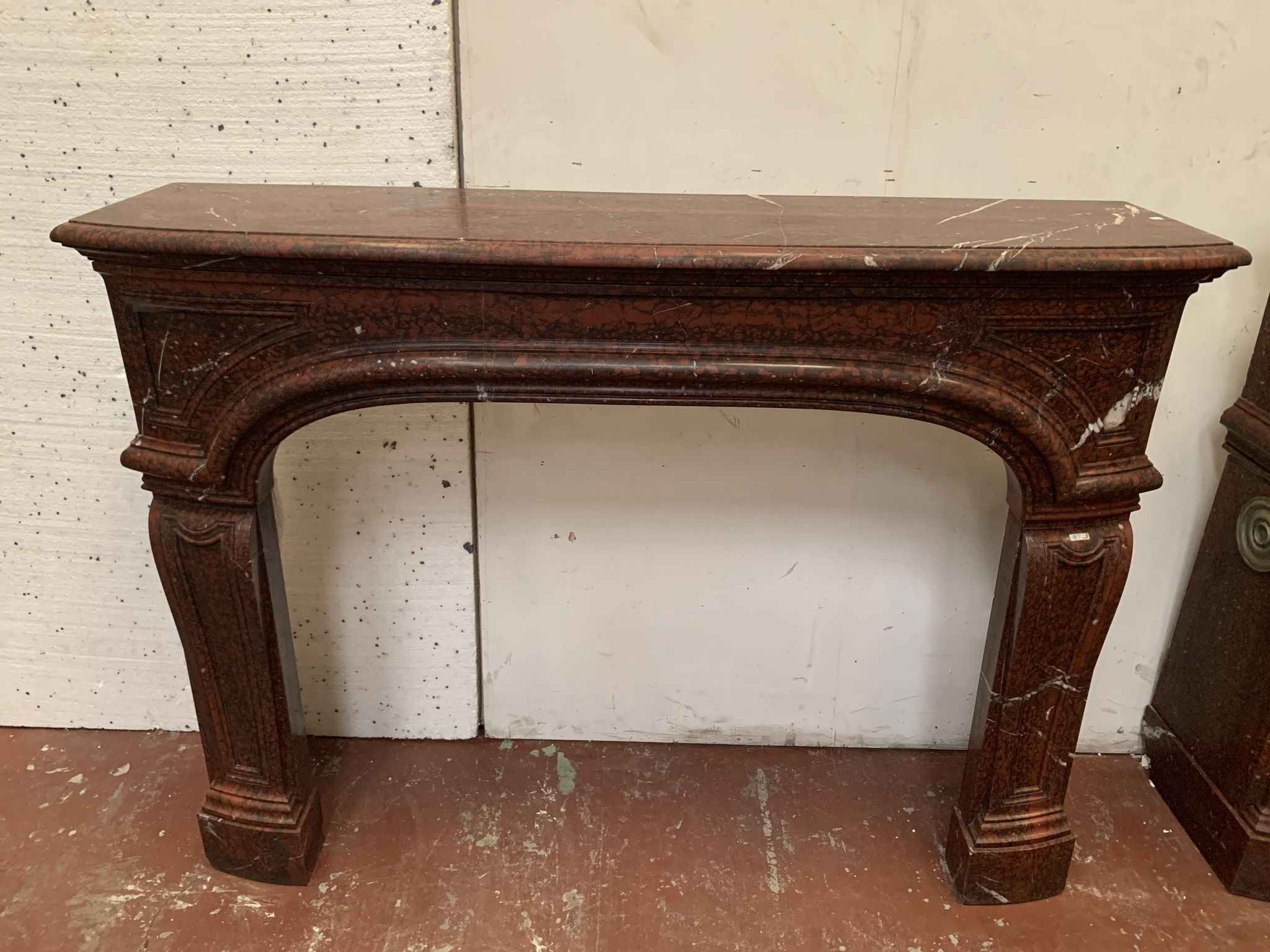 Pair of Louis XIV style fireplaces in red cherry marble. XIX century.