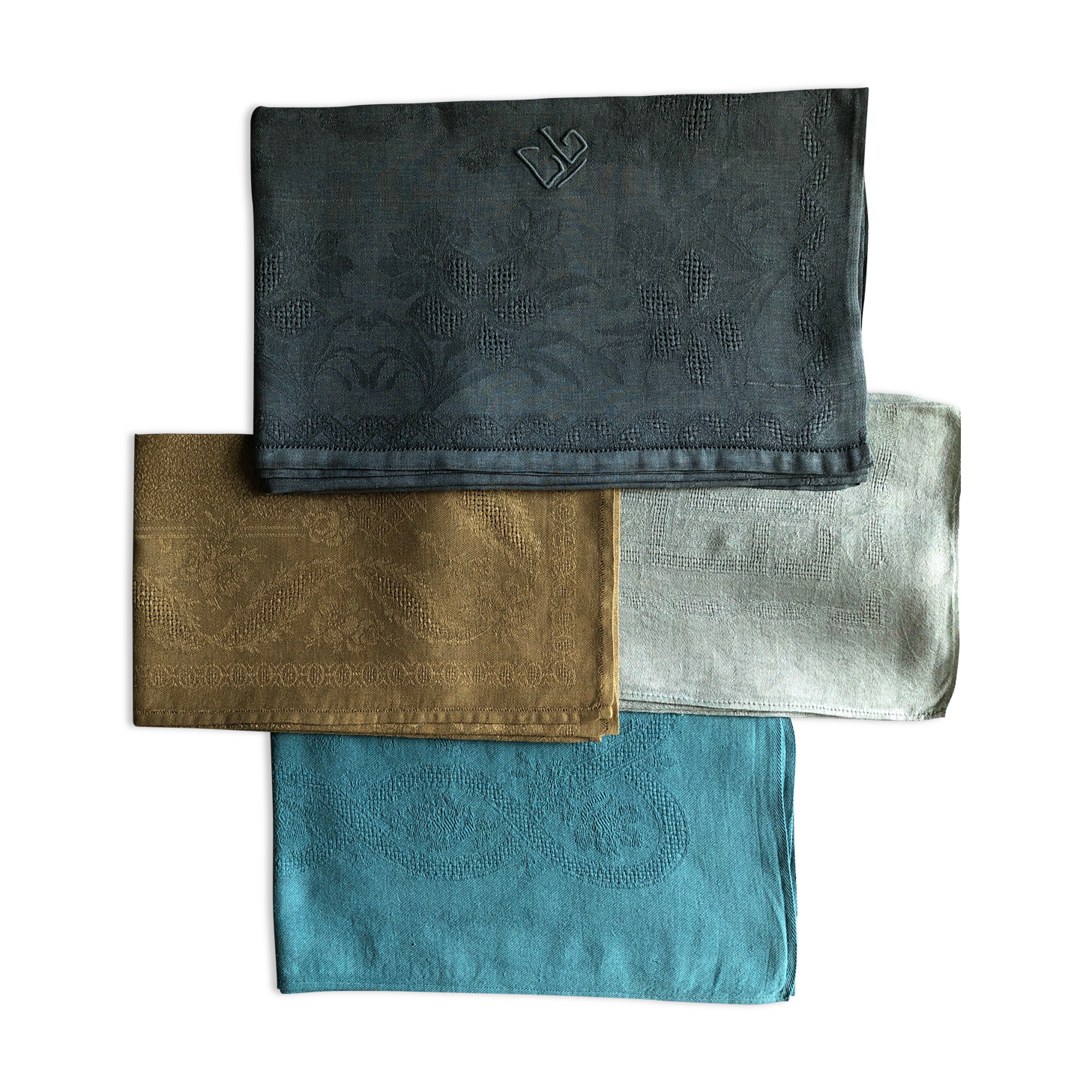 Suite of four tinted antique napkins
