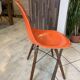 A vintage 70s Eames Herman Miller DSW Fiber Red Orange Dowel Walnut Chair