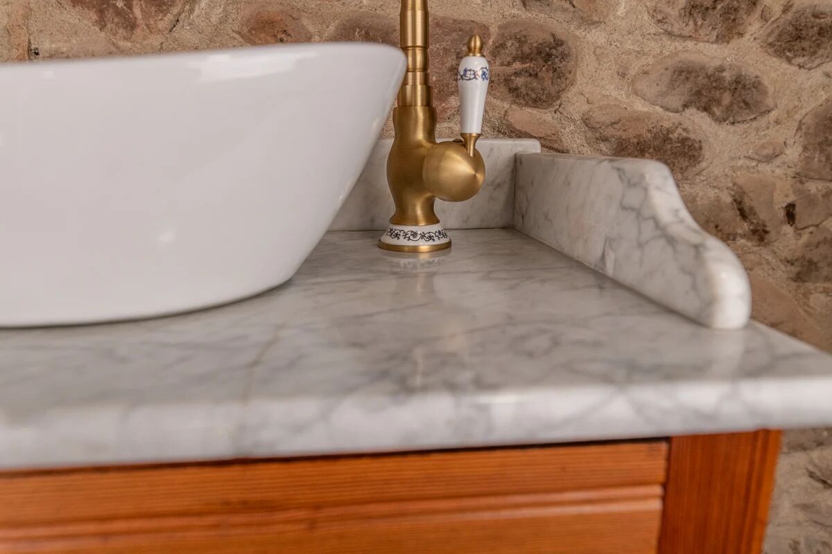 Antique washbasin cabinet in solid pitch pine with a white marble top.