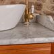 Antique washbasin cabinet in solid pitch pine with a white marble top.