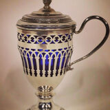 Solid silver mustard tree whose open body rests on a round pedestal.