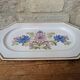 Rectangular earthenware dish with a glazed finish, decorated with a bouquet of flowers.