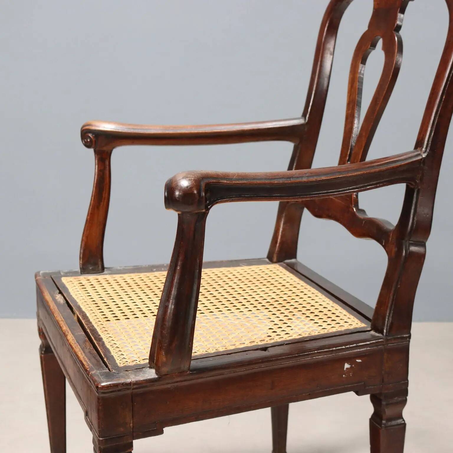 Antique walnut armchair with caned seat, Italy, 18th century