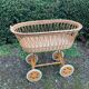 Vintage wicker cradle on casters