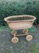 Vintage wicker cradle on casters