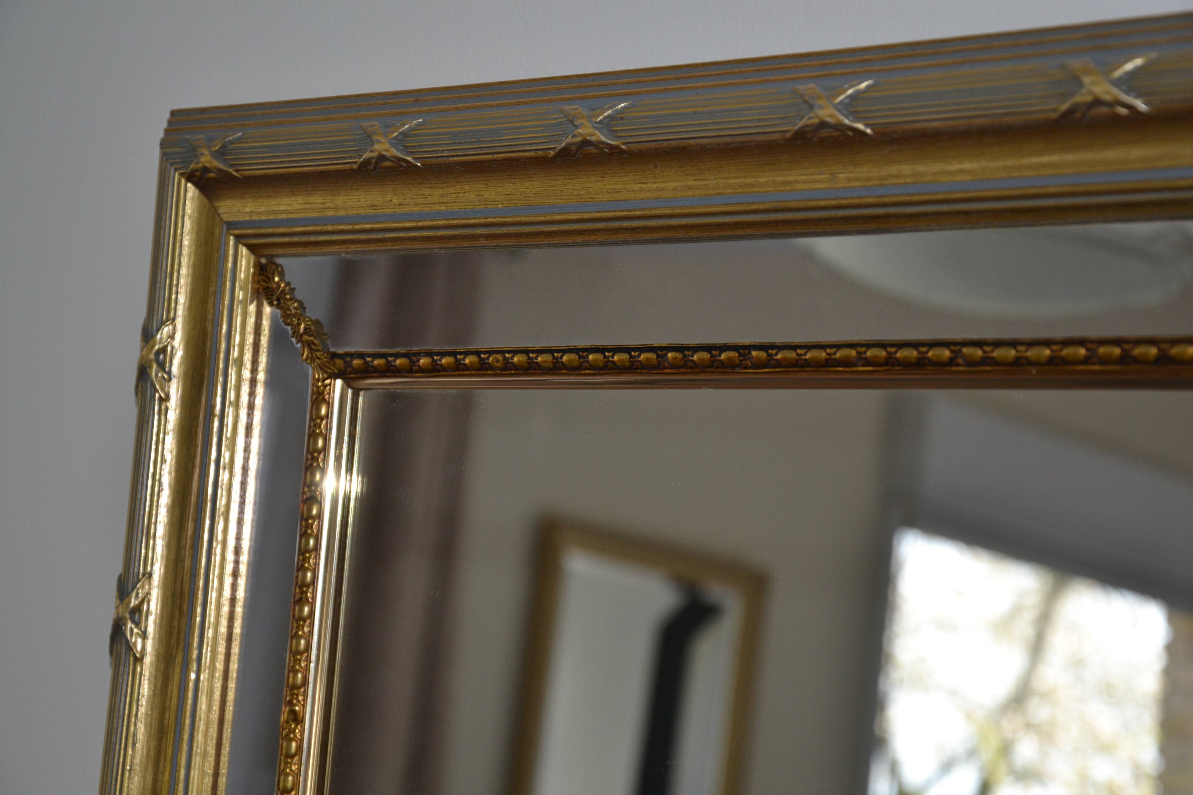 Large mirror with wooden gilded and carved frame.