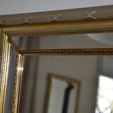 Large mirror with gilded and carved wooden glazing beads