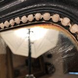 Napoleon III curved mirror, blackened wood frame with cream trim