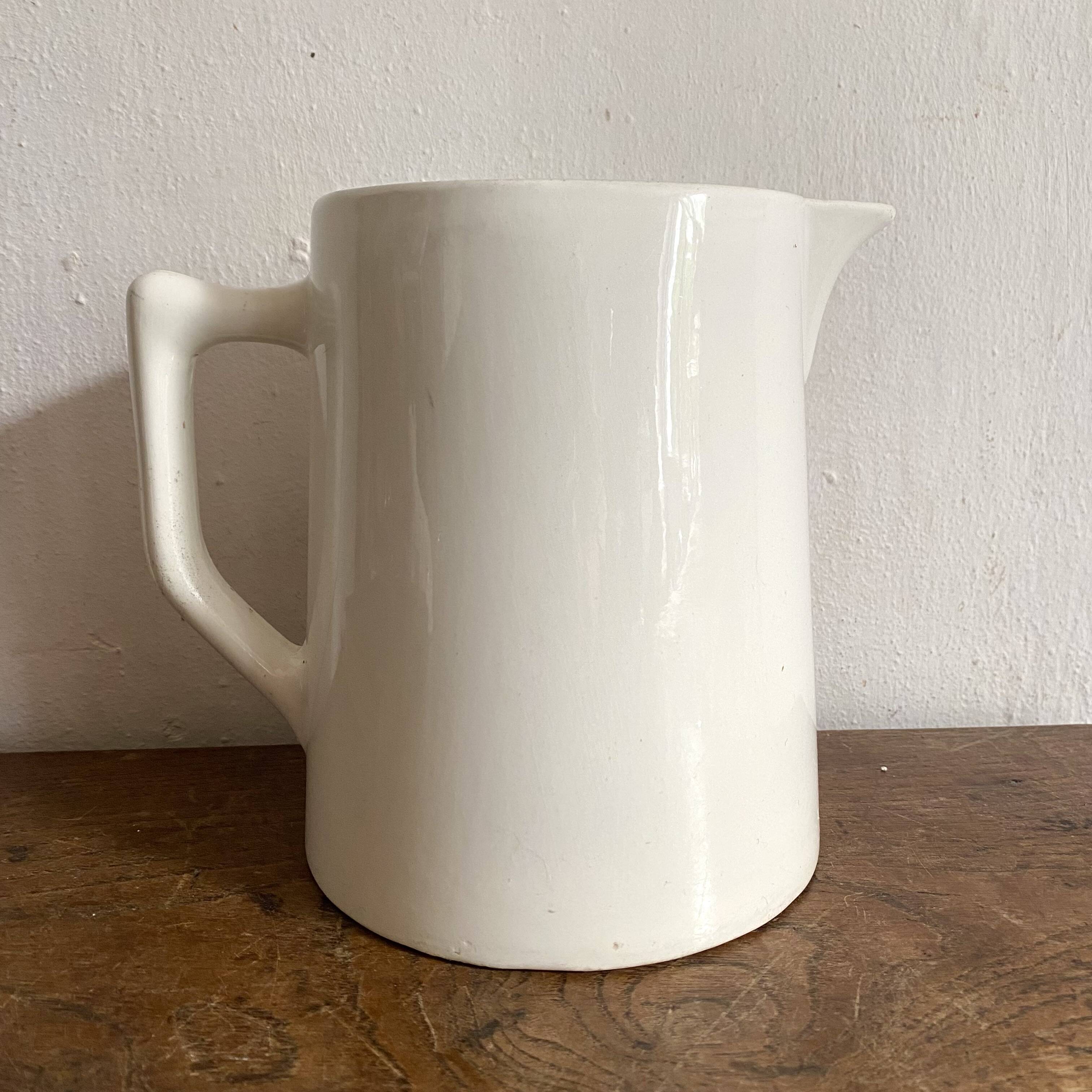 Old white earthenware jug