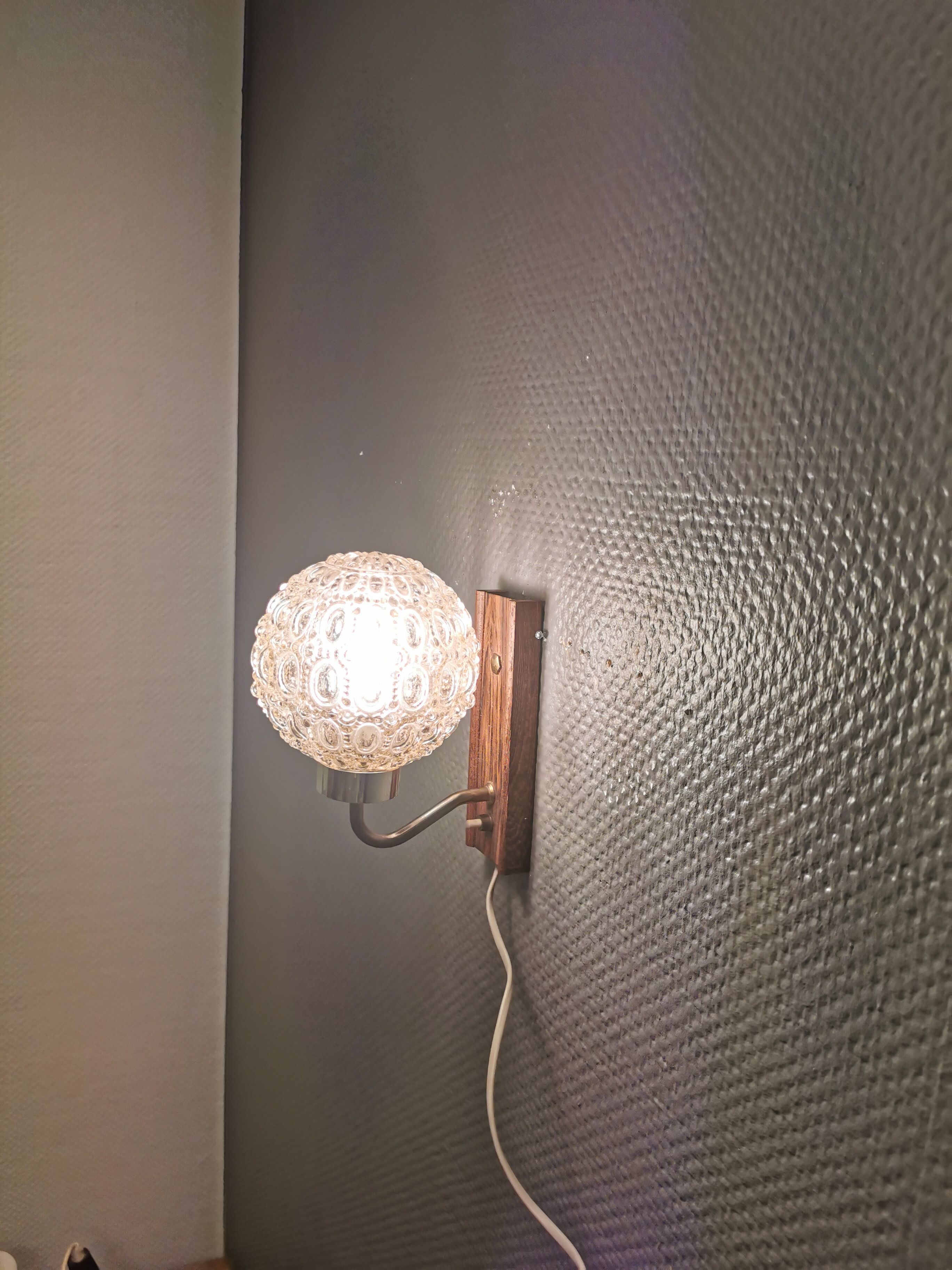 Wall light in rosewood with bobble glass ball shade.