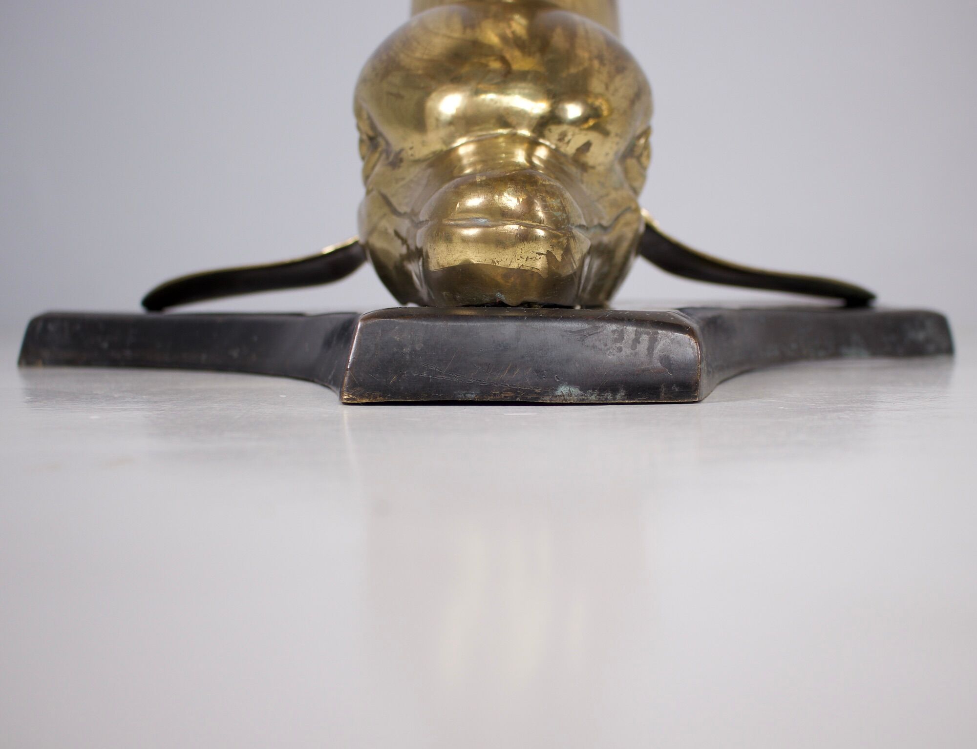 Solid brass dolphin console feet.
