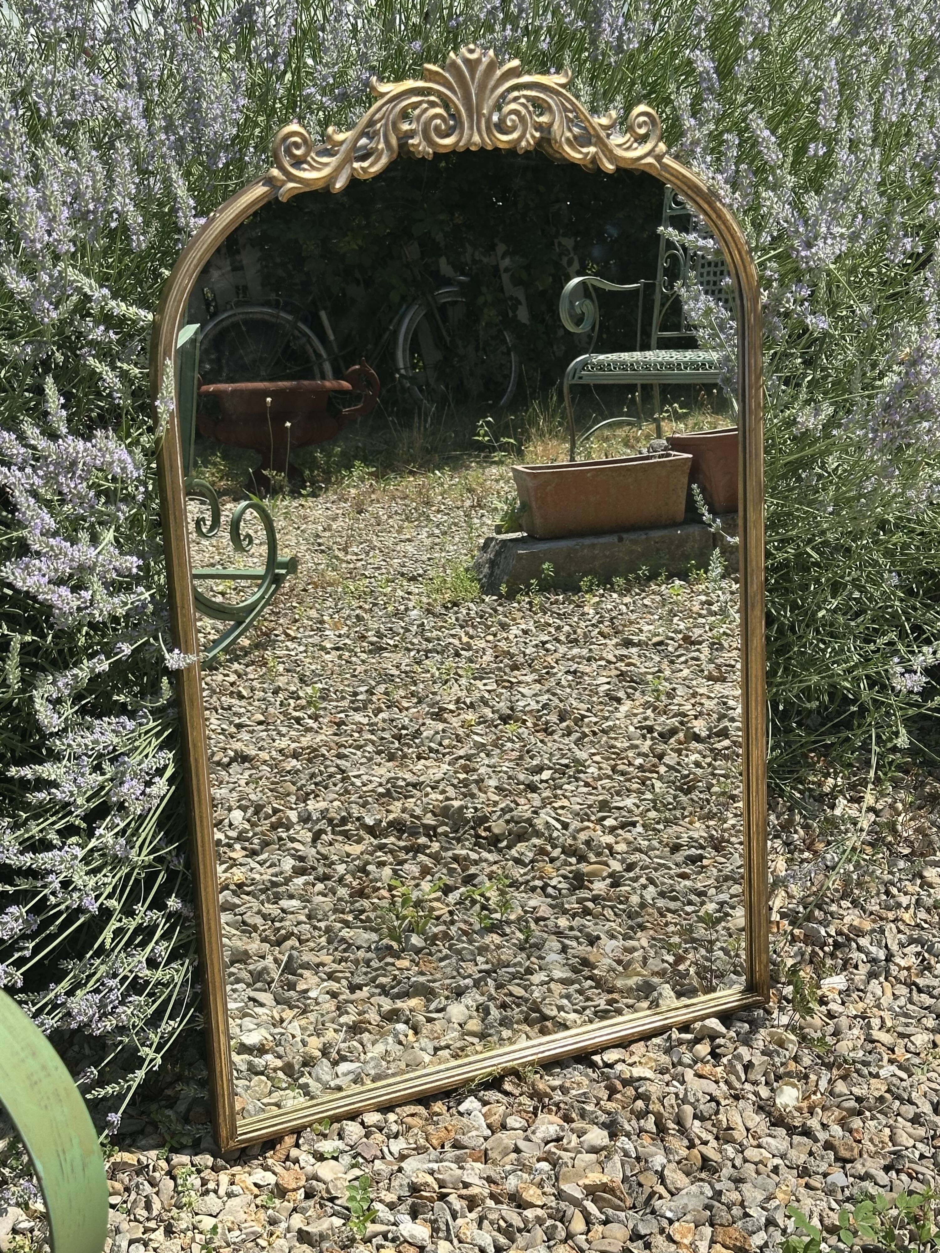 Golden metal pediment mirror from the 2000s.