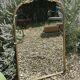 Golden metal pediment mirror from the 2000s.