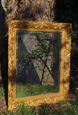 Wooden mirror decorated with gold from the 1920s