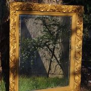 Wooden mirror decorated with gold from the 1920s