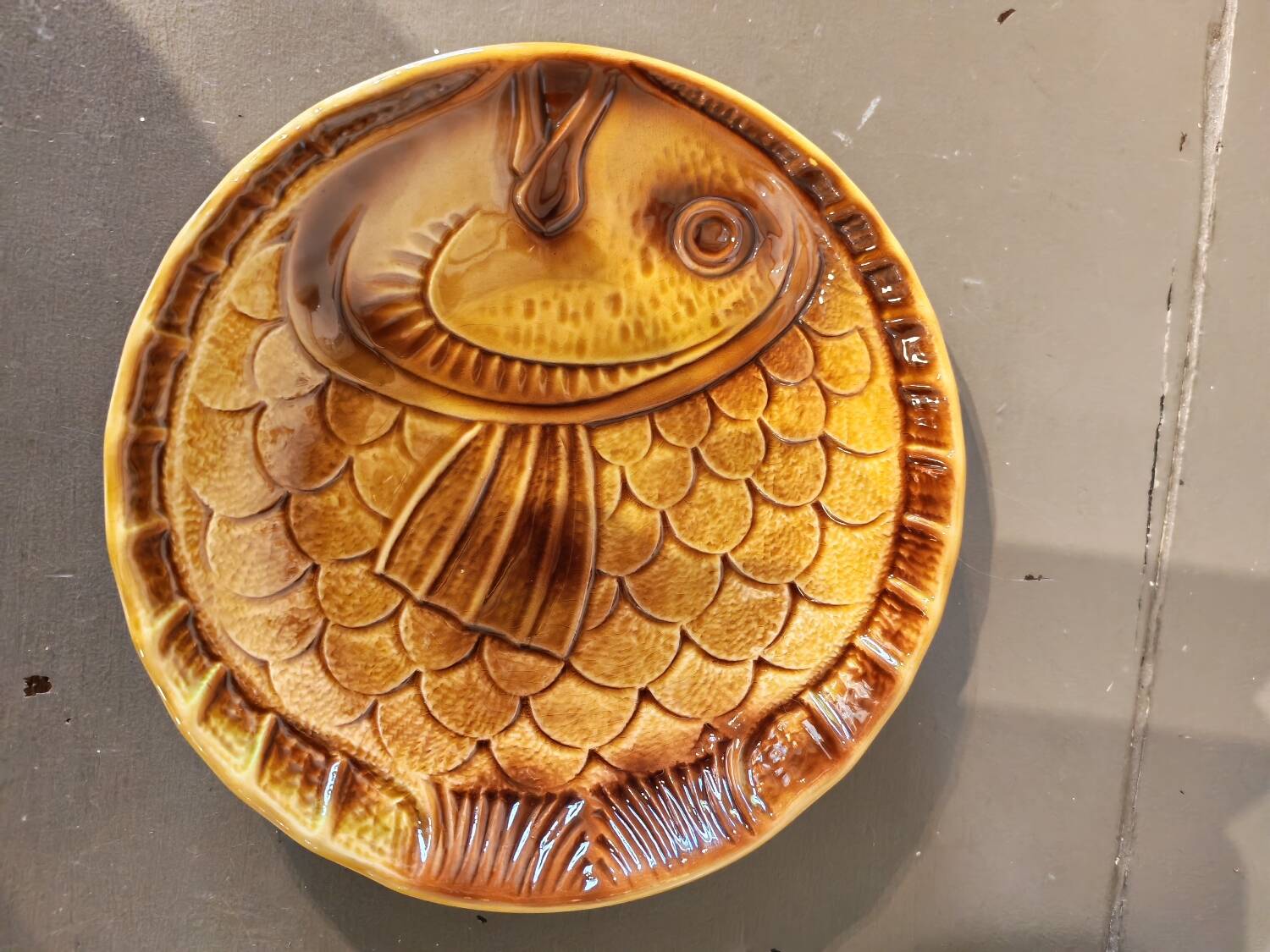 Vintage barbotine plates with fish decoration, 22 pieces.