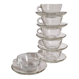 Six vintage transparent glass duralex cups and saucers