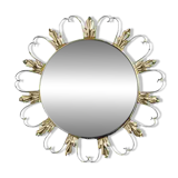 Round mirror on a brass frame with scrolls