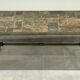Brutalist-style coffee table made of mixed wrought iron and stone.