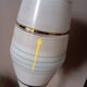 Mid-century gold metal table lamp with white striped shade