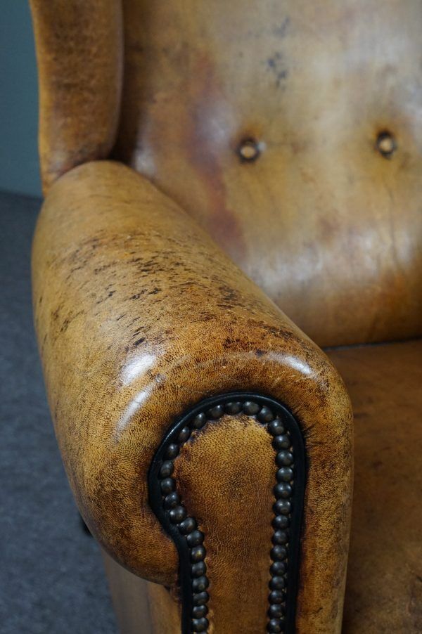 Antique armchair in patinated sheepskin