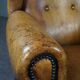 Antique armchair in patinated sheepskin