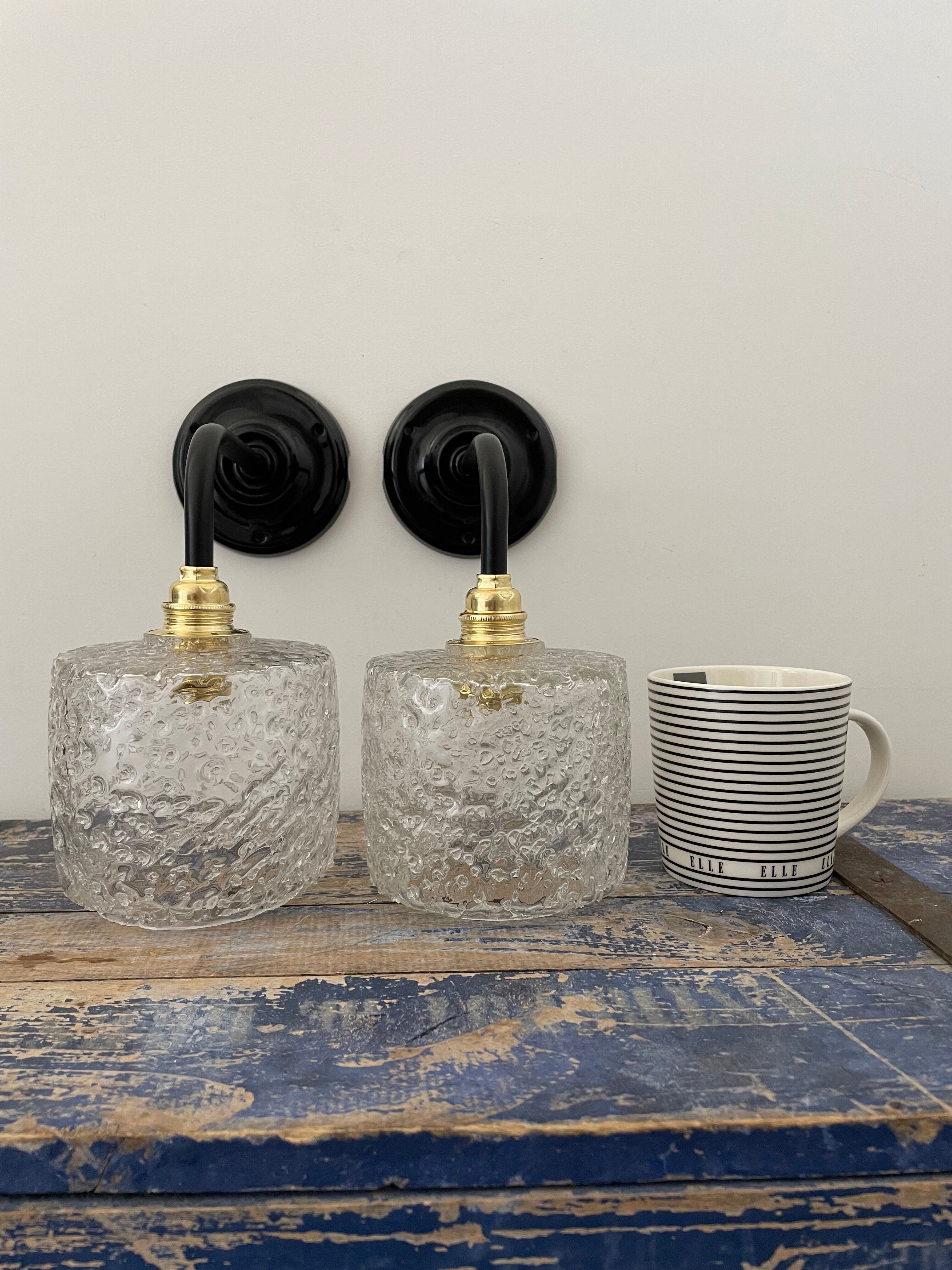 Set of two chiseled glass sconces