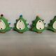 Four Christmas tree-shaped candle holders