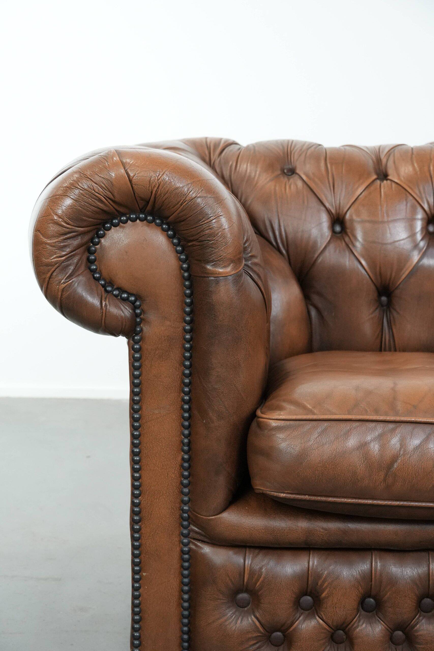 Brown cowhide leather chesterfield armchair  in English style on wheels